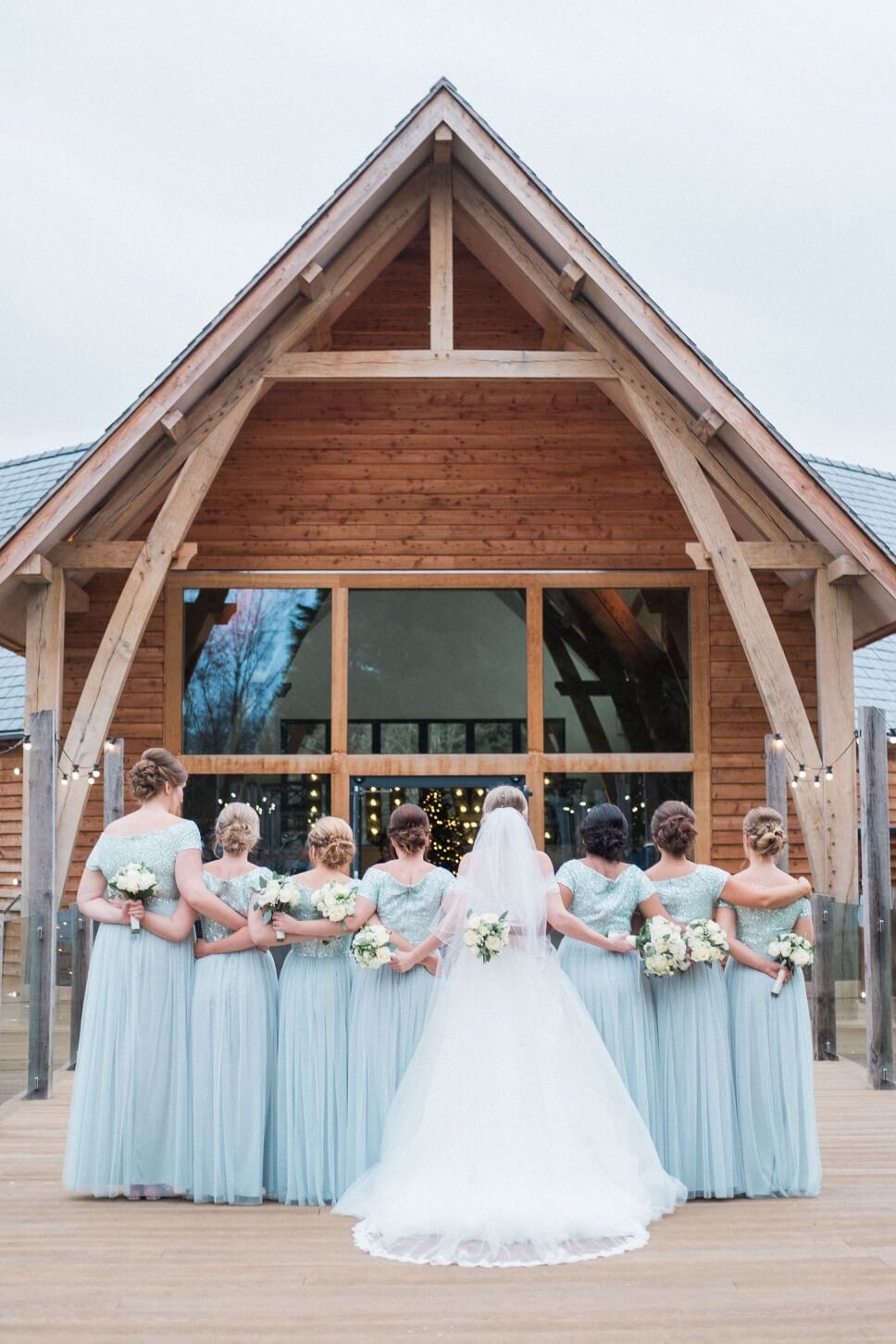 The bridal party showing the backs of their dresses