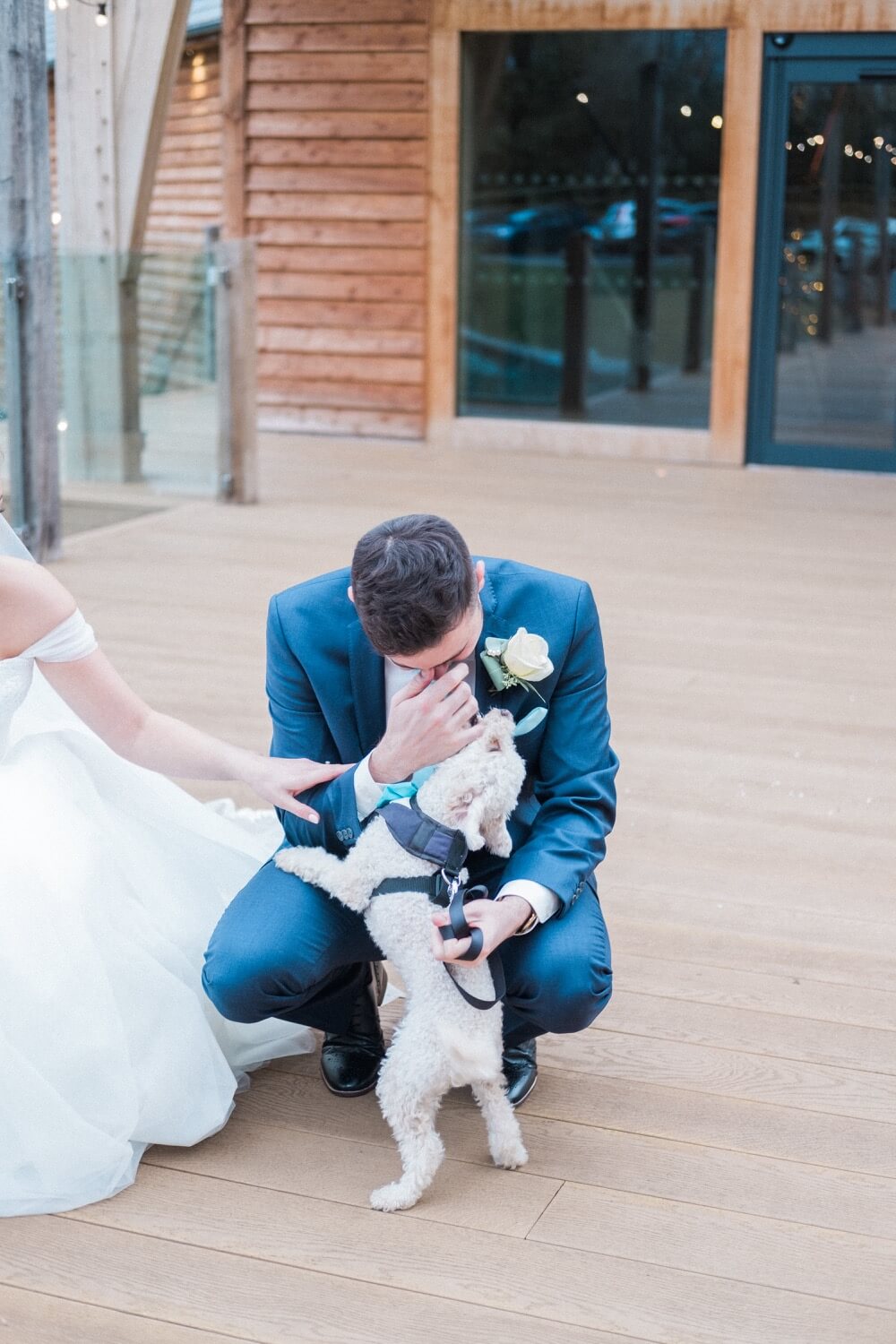 Groom in tears with their dog at The Mill Barns