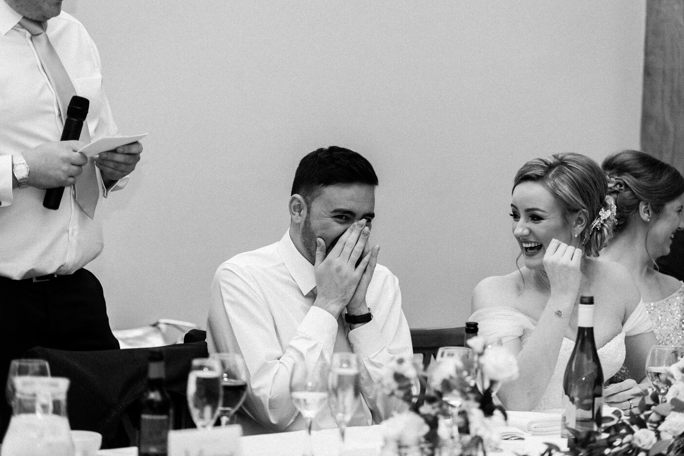 Groom reacting to the best man's speech