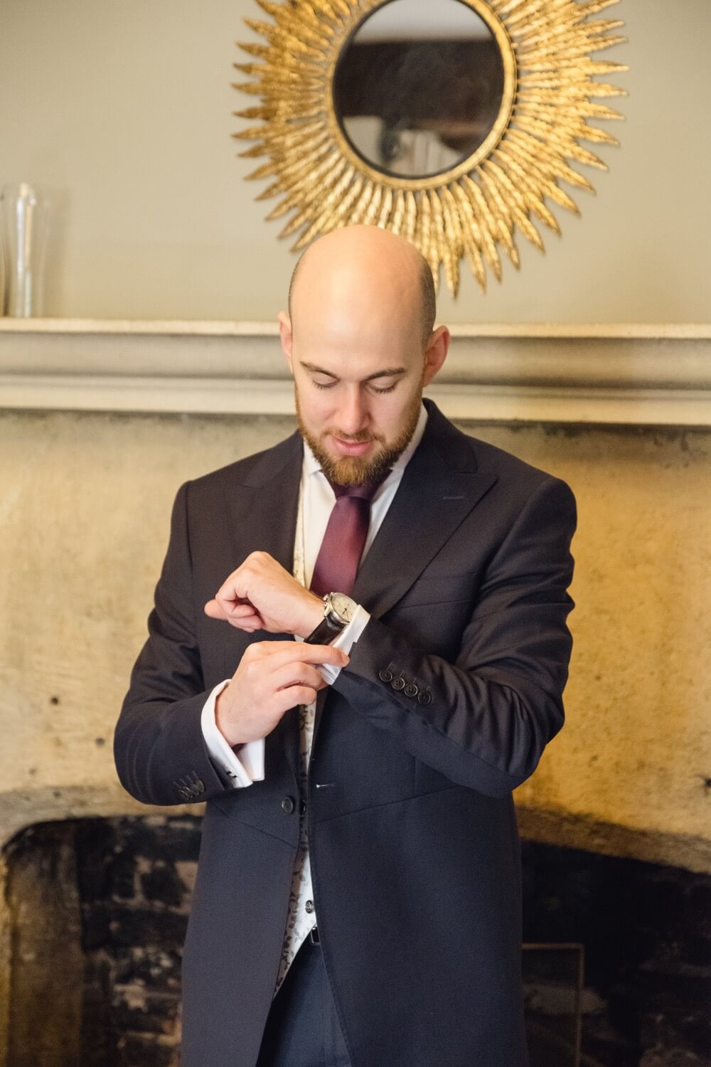 Groom adjusting his cufflinks