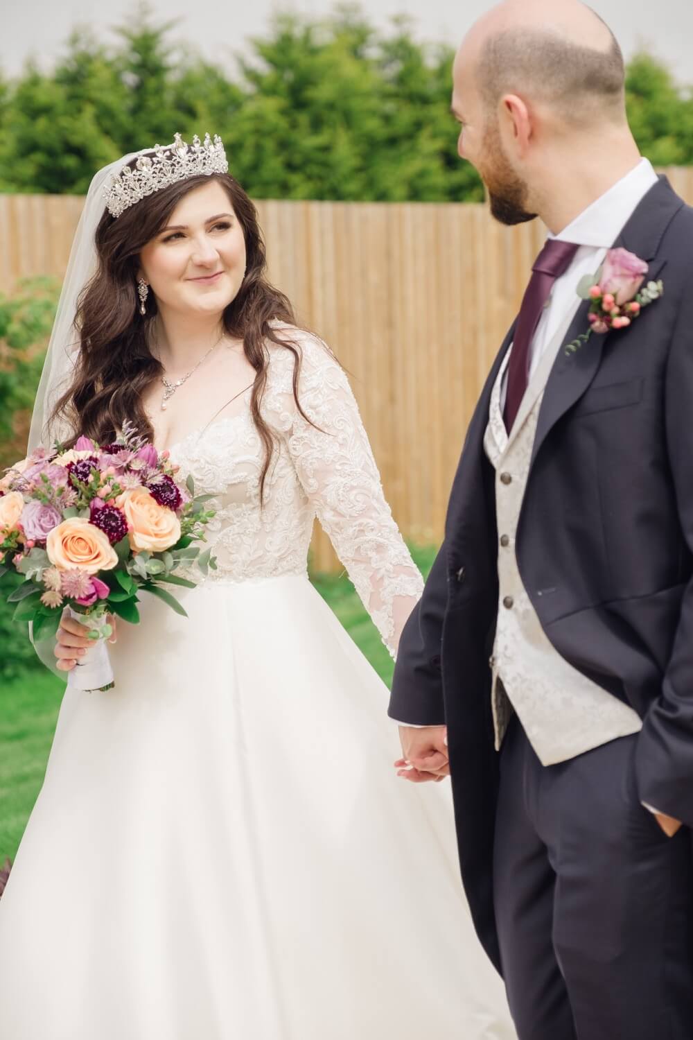 Bride and groom holding hands at The Pear Tree Purton