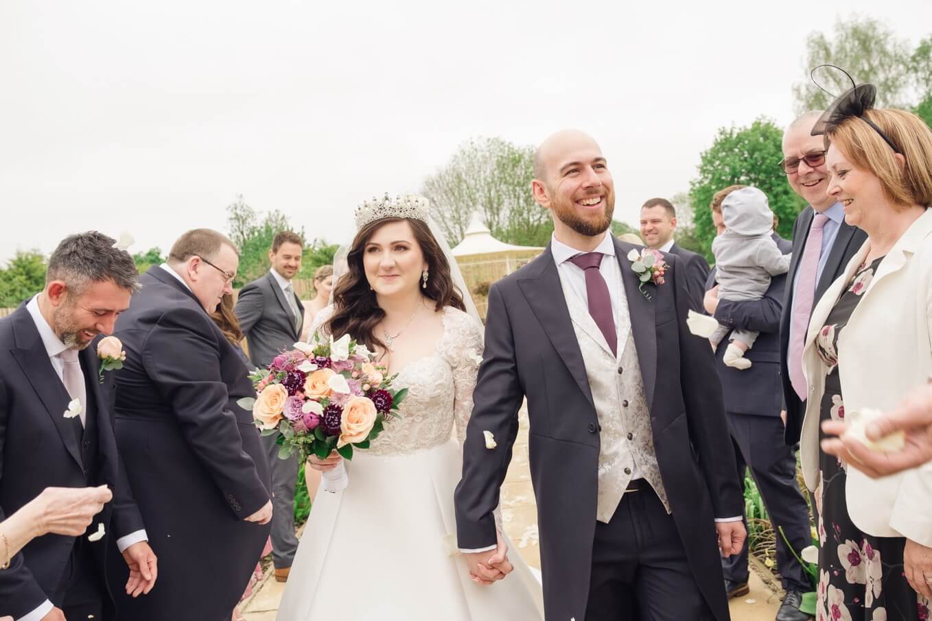 Confetti over the bride and groom during the drinks reception at The Pear Tree Purton