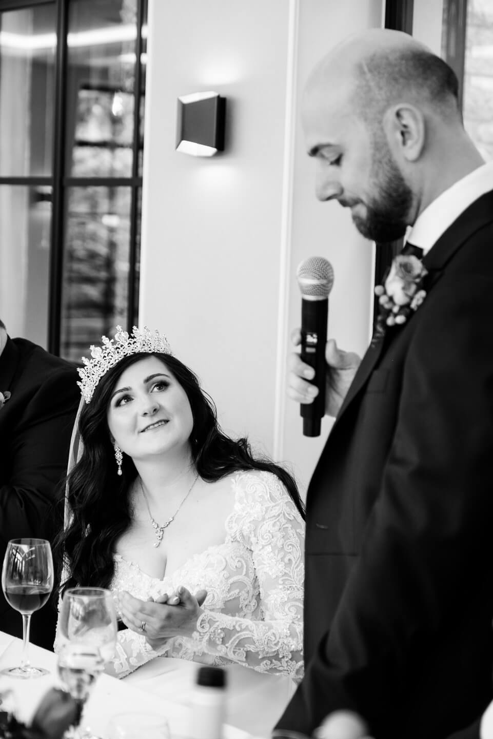Bride looking at the groom during the speeches at The Pear Tree Purton