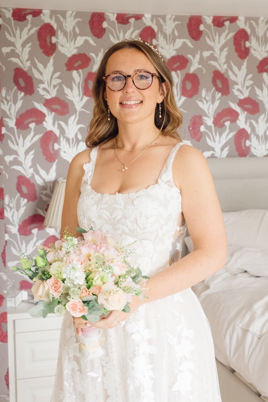 The bride smiling with her flowers