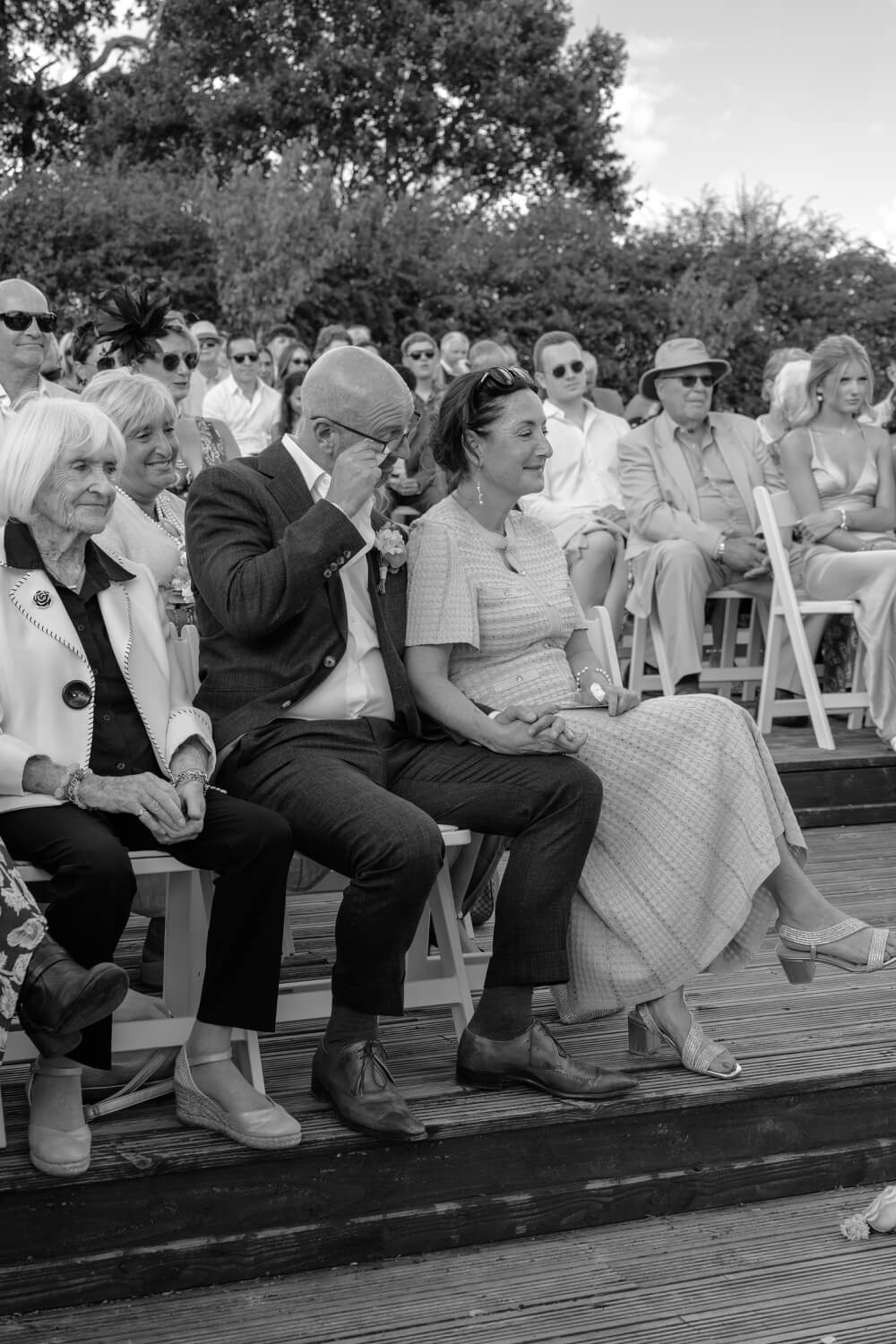 The father of the bride wiping away a tear