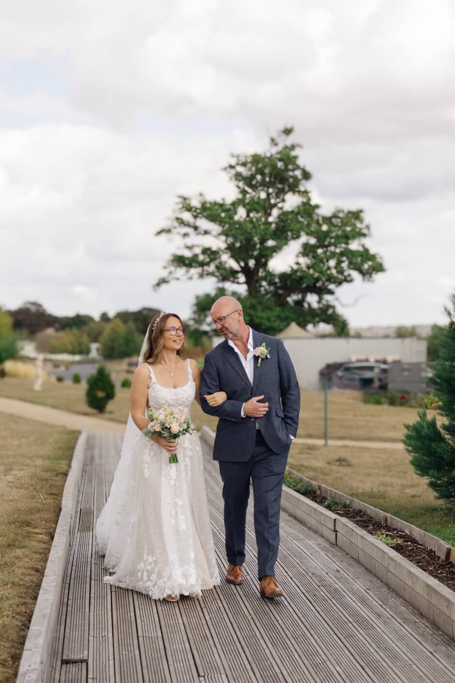The bride and her father walking down the aisle arm in arm
