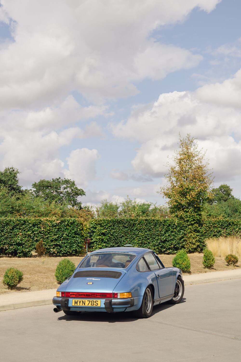 The groom arriving at Hencote in a blue Porsche