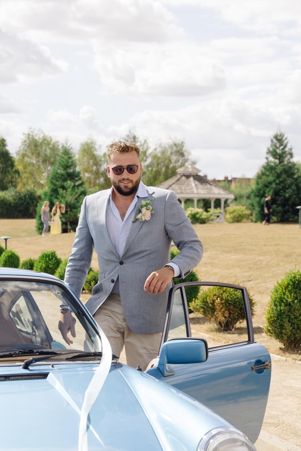 The groom getting out of the car at Hencote