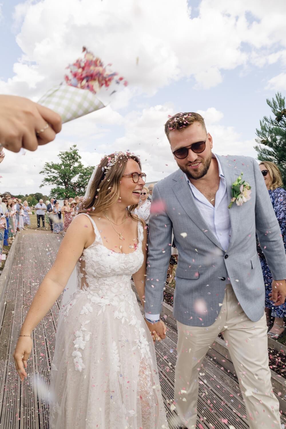 Confetti falling around the bride and groom