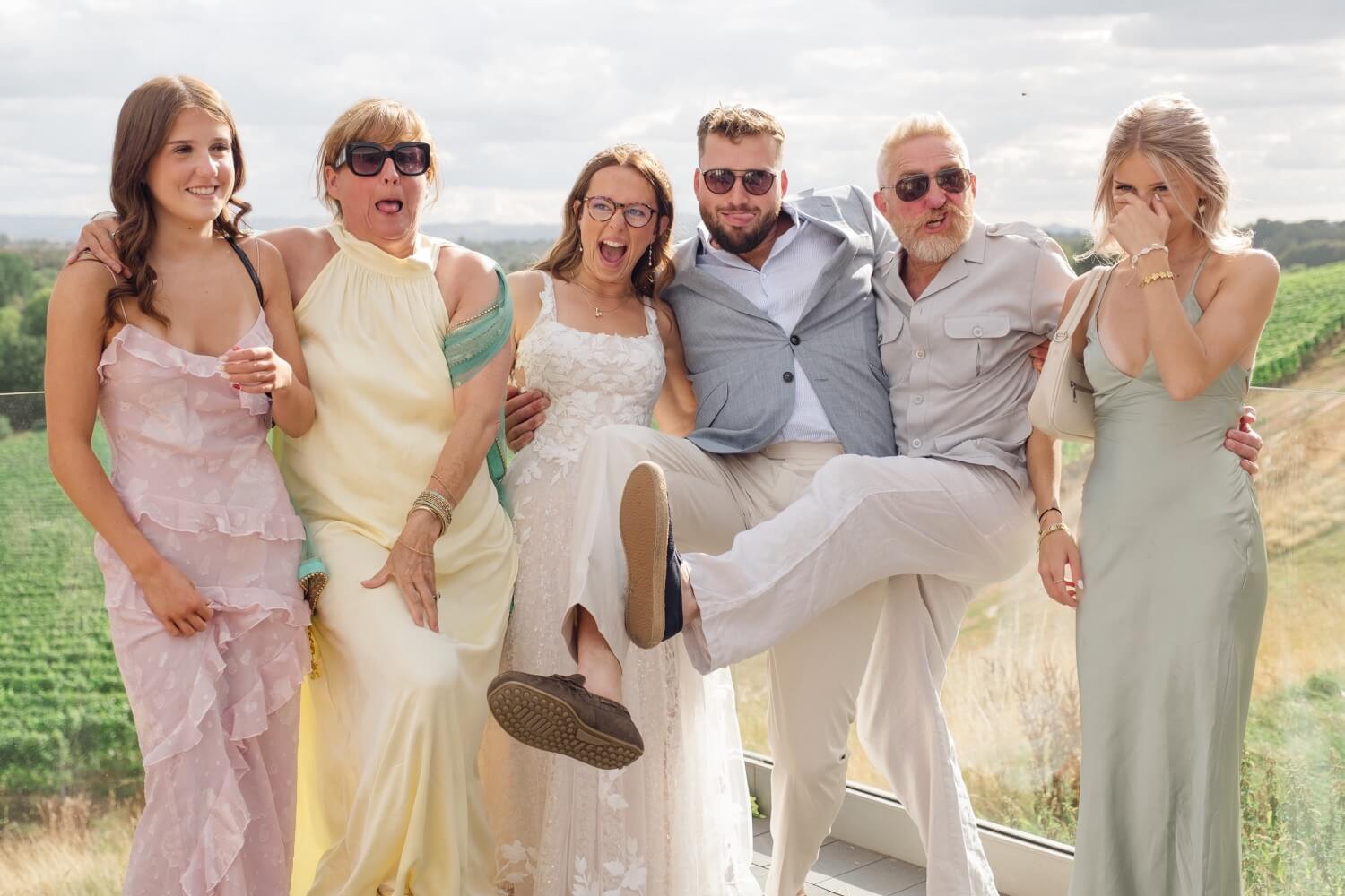 The couple and guests kicking their legs on the terrace