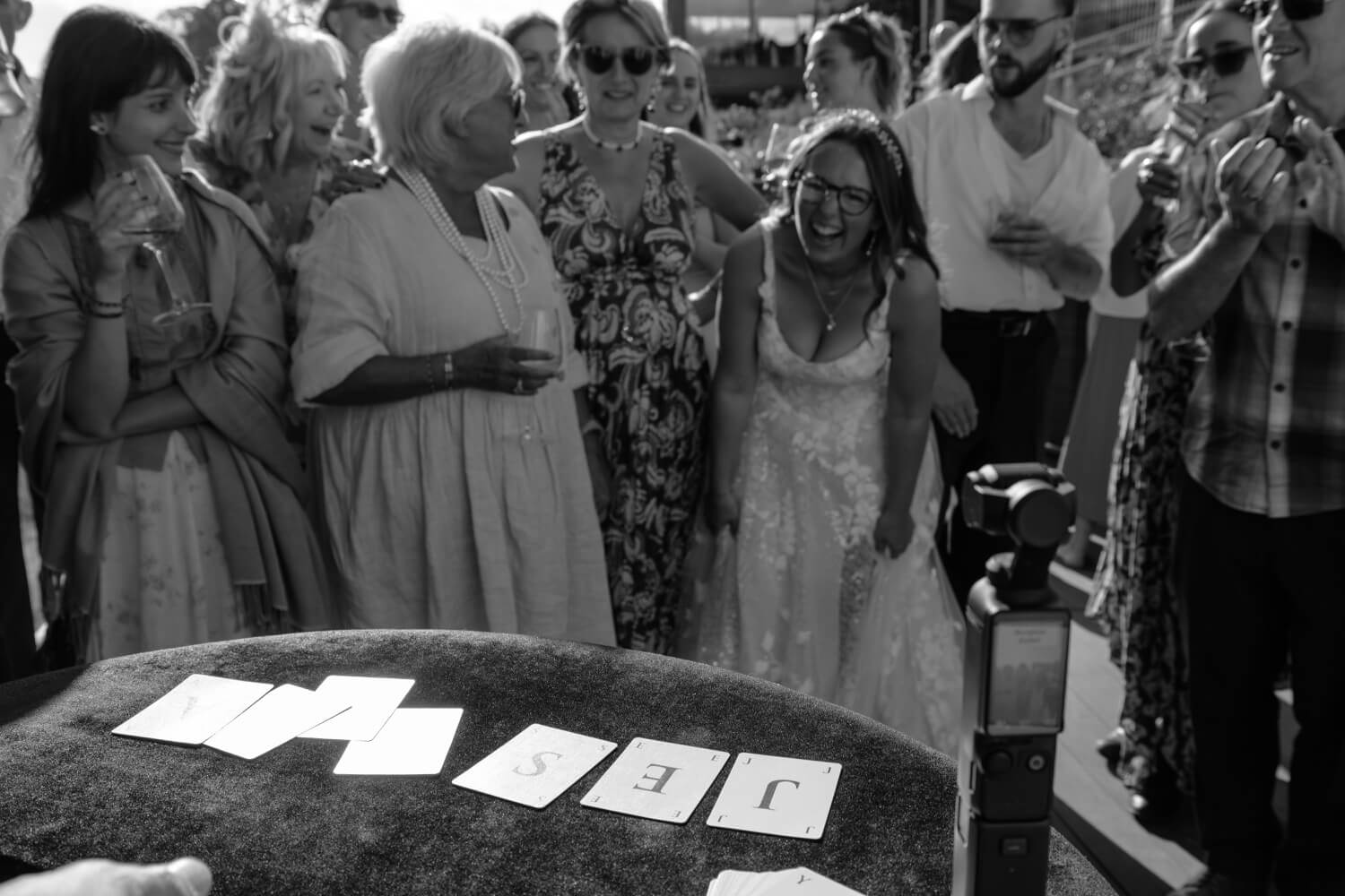 The magician performing a trick for the laughing bride