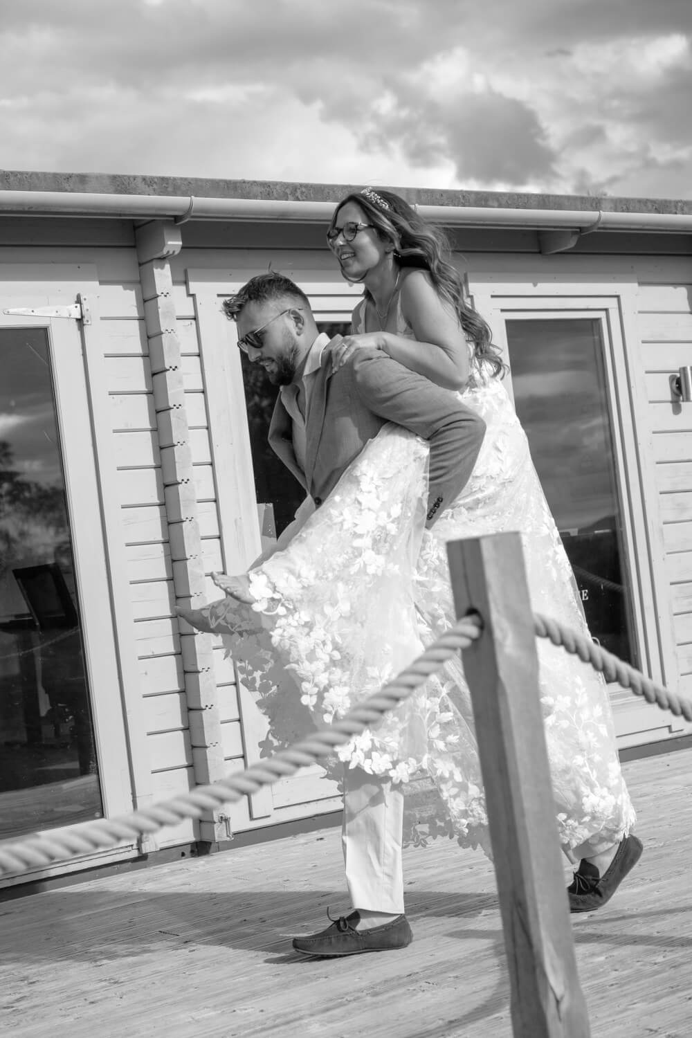 The groom giving the bride a piggyback