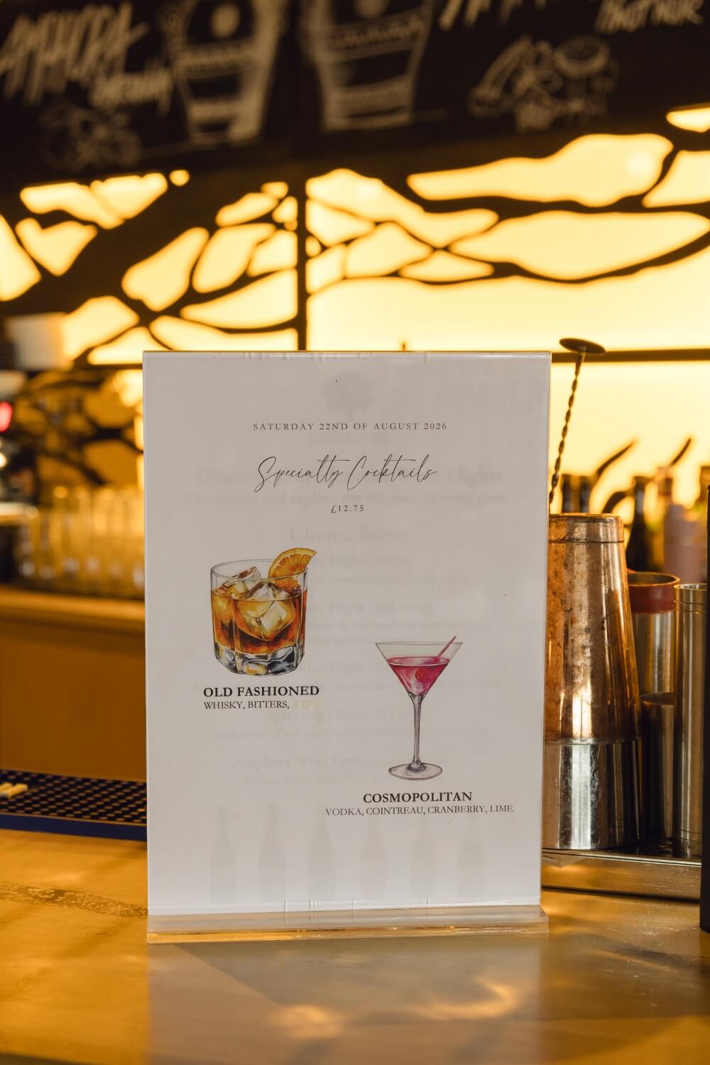A his and hers cocktail sign at the drinks reception