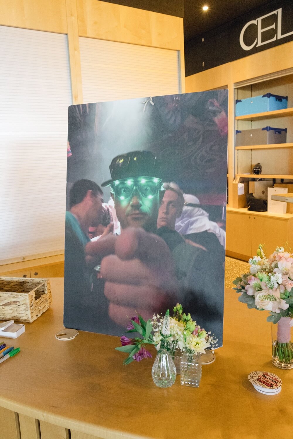 A guest holding up a photo of the groom