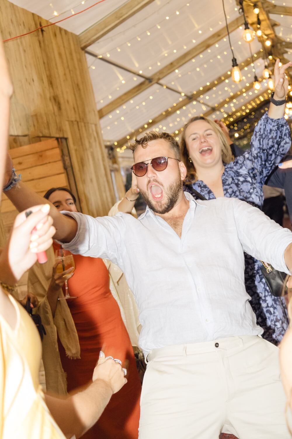 The groom dancing at the evening reception