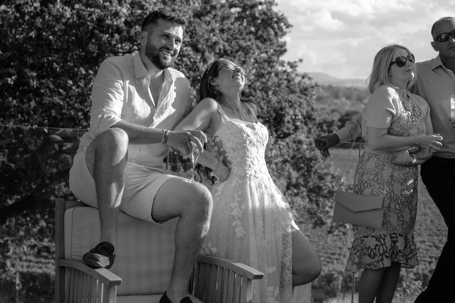 The bride and groom laughing during the speeches